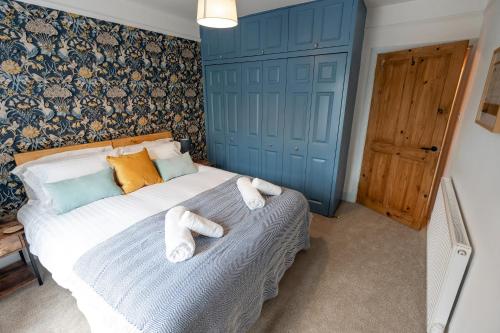 a bedroom with a bed with towels on it at Daffodil House in Cockermouth