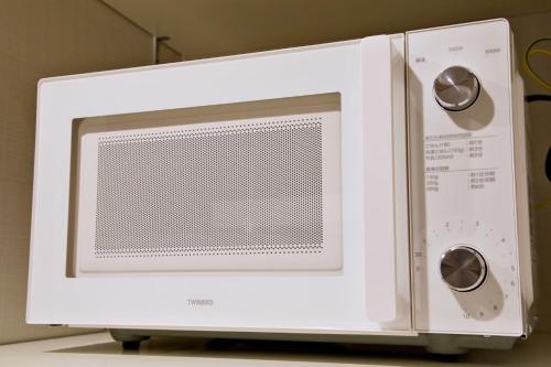 a white microwave oven sitting on top of a table at メイスン倶楽部 安里 4F in Naha