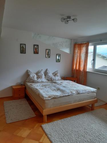 a bedroom with a bed and a window at TOP Mountain View in Volders