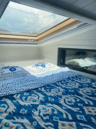 a large bed in a room with a window at Lovin Gocek & Tiny house Mermaid in Fethiye