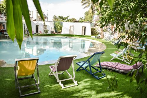 a group of chairs sitting next to a pool at Asmara Lifestyle Hotel in Cebu City