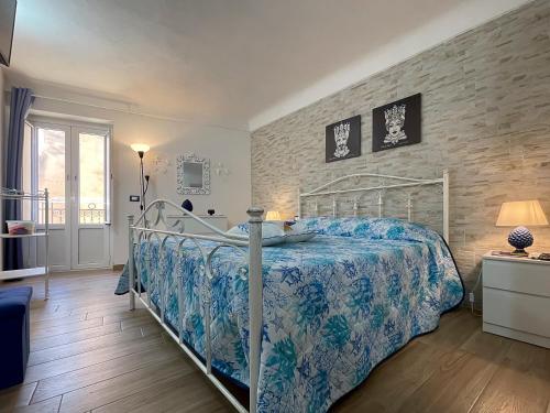 a bedroom with a bed and a brick wall at Domus Caricatore in Sciacca