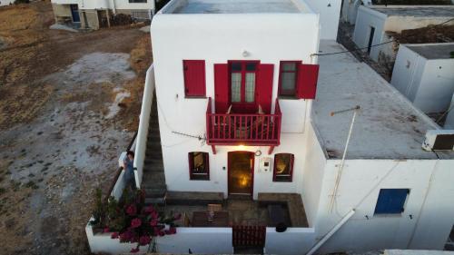 an aerial view of a house with red doors and stairs at Verantaki in Kithnos
