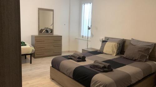 1 dormitorio con 1 cama grande, vestidor y espejo en Appartamento Centro Storico Porlezza en Porlezza