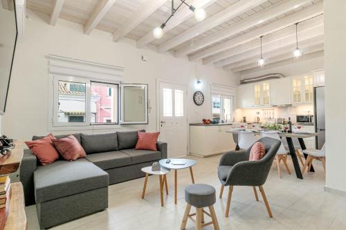 a living room with a couch and a kitchen at S&K Luxury Μaisonette in Potamós