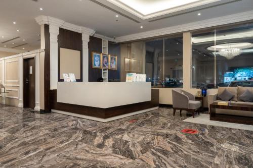 a lobby with a reception desk and a couch at Luxury Hospitality Serviced Apartments in Al Khobar