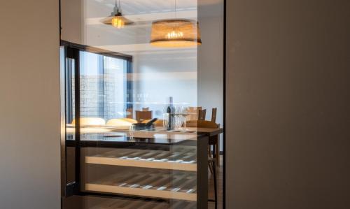 a glass display case with items inside of it at La Villa Thelma 5 étoiles, piscine, sauna et jacuzzi in Granville