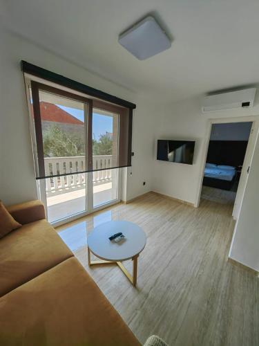 a living room with a couch and a table at Zvončica Deluxe in Vodice