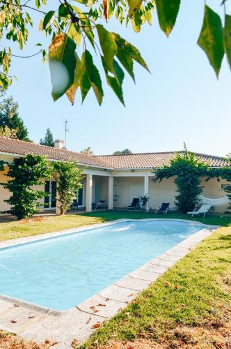 a swimming pool in front of a house at Just Like Home - Casa do Sobreiro Velho em Cerveira in Vila Nova de Cerveira