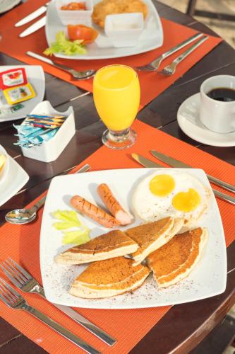 a plate of food with eggs and carrots on a table at Ecohabs Tequendama - Parque Tayrona in El Zaino