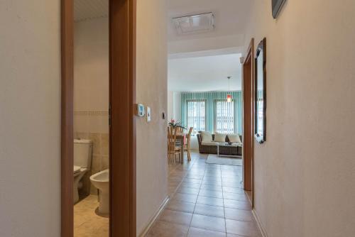 a hallway with a bathroom and a living room at Villa ADORA in Balchik