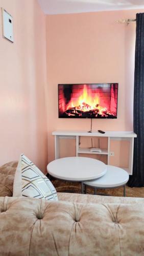 a living room with a couch and a fireplace at Executive Studio in Nakuru