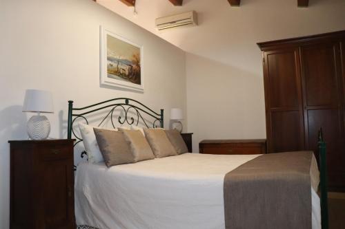 a bedroom with a large bed with a wooden cabinet at Il Terrazzo Sul Sinni in Rotondella