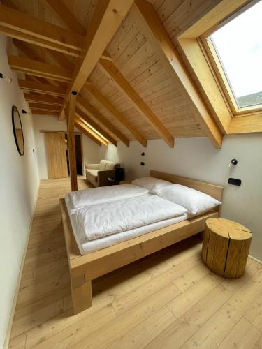 a bedroom with a large bed and a skylight at Penzion Kolnička in Luka nad Jihlavou