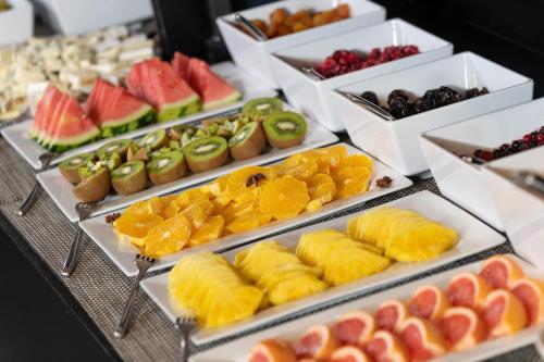a buffet of different types of fruits and snacks at Martin's Brussels EU in Brussels