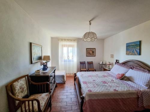 a bedroom with a bed and a table and chairs at Appartamenti Tortorella in Pelago