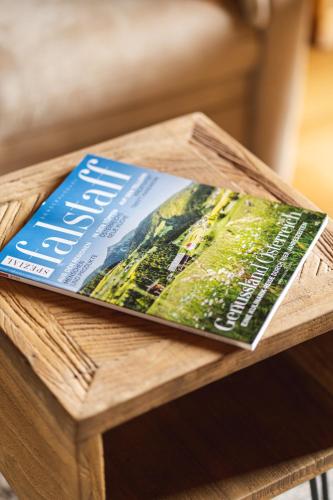 a magazine sitting on top of a wooden table at Gasthof-Appartements Sportalm in Bad Kleinkirchheim