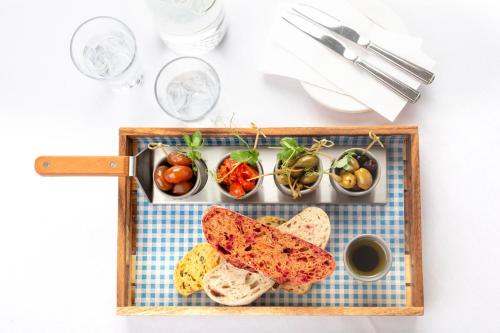 a tray of food with bread and vegetables on a table at Honest Lawyer Hotel in Durham