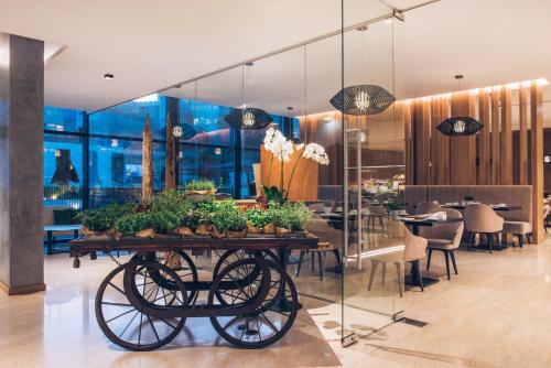 a dining room with a table with plants on it at Iberostar Selection Lisboa in Lisbon