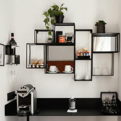 a wall with black shelves on a white wall at Montenapoleone Suites in Milan