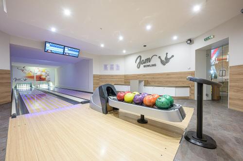 a bowling alley with balls in the lanes at Jam Panzió in Kapuvár