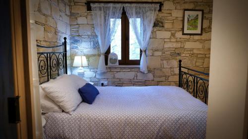 a bedroom with a bed and a stone wall at Haven in Limassol