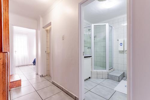 a bathroom with a walk in shower and a toilet at Mzingazi Waterfront Accommodation, On The Bay Waterfront Villa's in Richards Bay