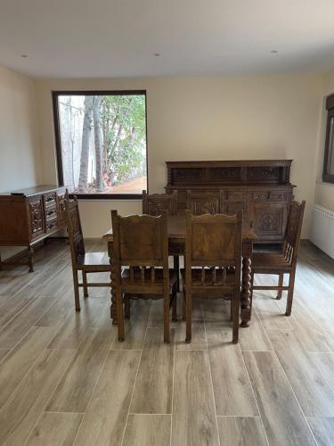 a dining room with a table and chairs and a piano at Casa Gala VUT in Santa María del Páramo