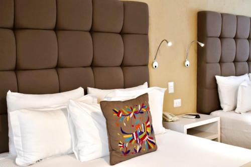 a bedroom with a bed with white pillows at Casa Pepe in Puebla