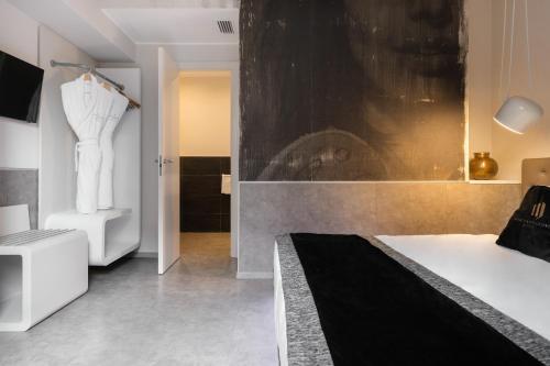 a bedroom with a white bed and a black wall at Montenapoleone Suites in Milan