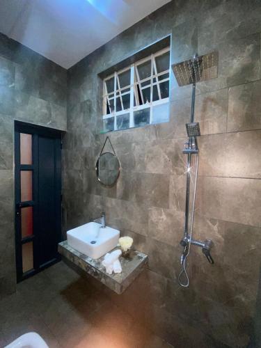 a bathroom with a sink and a shower at VILLA L'OR with Private Pool in Flic-en-Flac