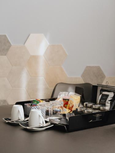 a black lunch box with plates and utensils on a table at Montenapoleone Suites in Milan