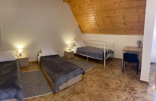 a bedroom with two beds and a desk and a table at NOCLEGI Grojec in Grojec