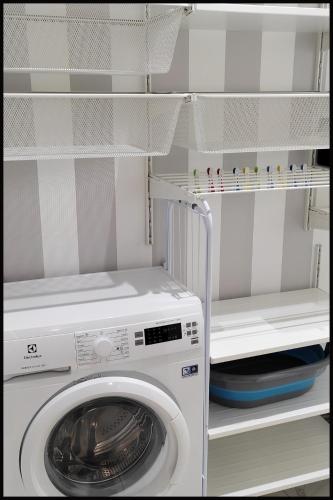 a washer and dryer in a white refrigerator at Casa Vacanze Borc dai Cucs in Faedis