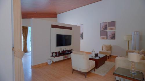 a living room with a couch and a tv at Marco Polo Resort Kaghan in Kāgān