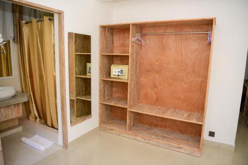 a bathroom with a shower with a wooden door at Maison Du Nord in Pointe aux Cannoniers