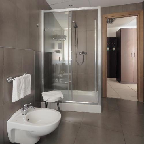 a bathroom with a sink and a shower and a toilet at Hotel Margherita in Monterosso al Mare