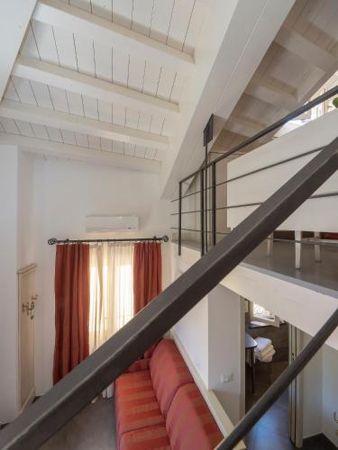 a staircase in a house with a red couch at Hotel Margherita in Monterosso al Mare