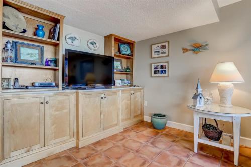 a living room with a tv and a table at 1029 Captains Court in Fernandina Beach