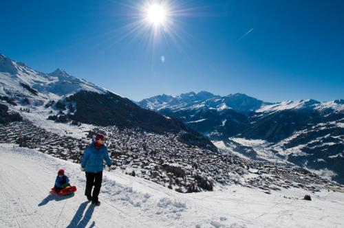 a woman and a child standing on a snow covered mountain at Hotel Montpelier in Verbier