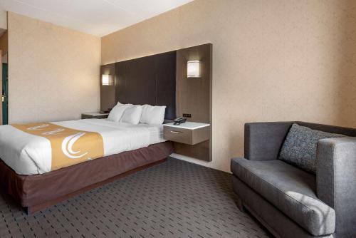 a hotel room with a bed and a chair at Quality Inn Montgomeryville-Philadelphia in Montgomeryville