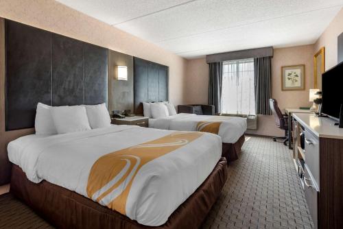 a hotel room with two beds and a television at Quality Inn Montgomeryville-Philadelphia in Montgomeryville