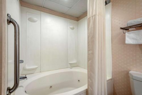a white bath tub in a bathroom with a shower at Quality Inn Montgomeryville-Philadelphia in Montgomeryville