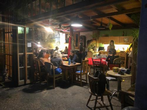 a group of people sitting at tables in a restaurant at Sandino Hostel - Solo Traveler Sanctuary in Berlin