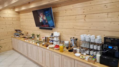 a breakfast bar in a room with wooden walls at Willa jak u Babci in Wisła