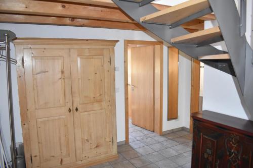 an attic room with wooden cabinets and a door at Beal Lia Haus C 474 Bh Whg 8 in Lenz