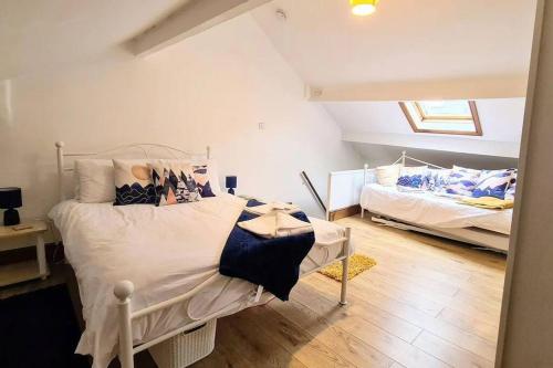 a bedroom with two beds in a attic at 2 bedroom Victorian canal side terrace house. in Hebden Bridge