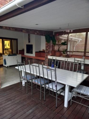 a dining room with a table and chairs on a deck at Plettenberg Bay 7 BUNKER AVENUE in Plettenberg Bay