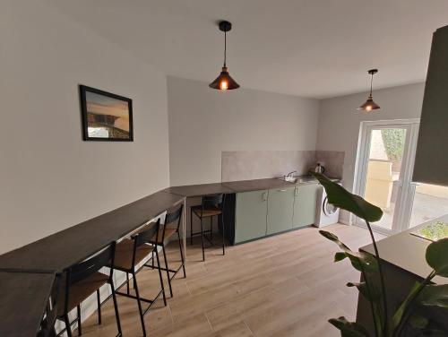 a kitchen with a counter and chairs in a room at Recently Renovated Dublin City House in Dublin