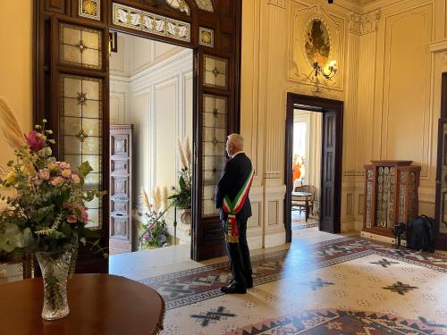 a man standing in a hallway in a building at Villa Tina Hotel in Viareggio